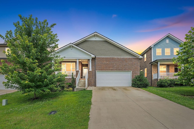 832 Green Meadow Ln, Smyrna, TN 37167 - view of front of house with a porch, concrete driveway, a front yard, and brick siding