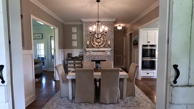 7680 Barnhill Rd, Primm Springs, TN 38476 - dining area with a chandelier, wood finished floors, crown molding, and a brick fireplace