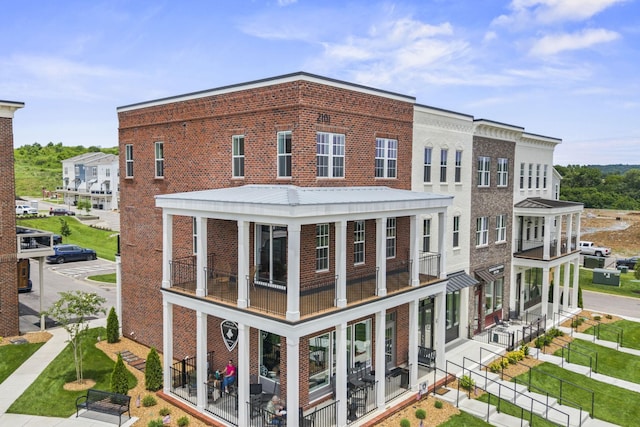 2101 Branford Pl Unit 201, Thompsons Station, TN 37179 - back of house featuring brick siding and a balcony