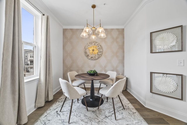 2101 Branford Pl Unit 201, Thompsons Station, TN 37179 - dining room featuring wallpapered walls, an accent wall, a chandelier, ornamental molding, and dark wood-type flooring