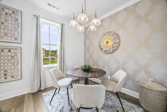 2101 Branford Pl Unit 201, Thompsons Station, TN 37179 - dining space featuring ornamental molding, healthy amount of natural light, a chandelier, and wood finished floors