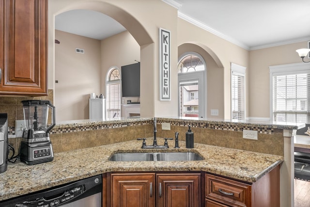 3351 Cotham Ln, Clarksville, TN 37042 - kitchen featuring dishwasher, arched walkways, light stone countertops, plenty of natural light, and crown molding