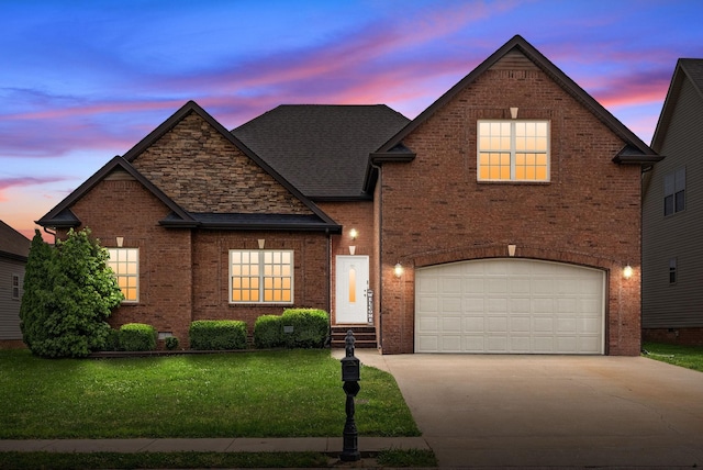 3351 Cotham Ln, Clarksville, TN 37042 - view of front facade with driveway, a front yard, brick siding, and an attached garage