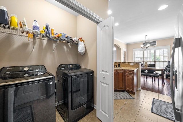 3351 Cotham Ln, Clarksville, TN 37042 - laundry area with washing machine and clothes dryer, a chandelier, ornamental molding, light tile patterned floors, and recessed lighting