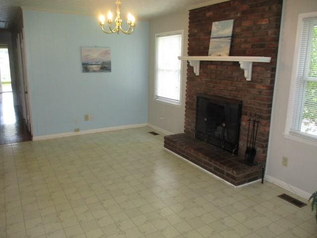 829 Kenny St, Gallatin, TN 37066 - unfurnished living room with plenty of natural light, a chandelier, a brick fireplace, and light floors