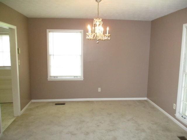 829 Kenny St, Gallatin, TN 37066 - spare room with a chandelier, light colored carpet, and plenty of natural light