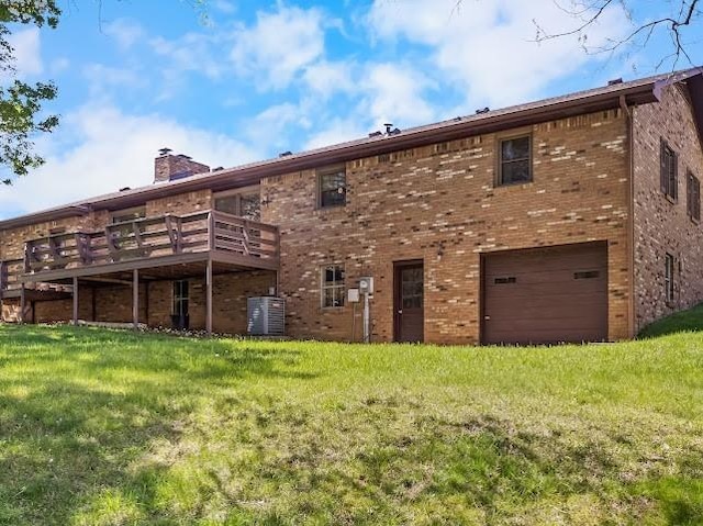 2355 Davidson Graveyard Rd, Clarksville, TN 37043 - back of house with brick siding, a chimney, a garage, and a yard