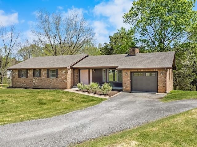 2355 Davidson Graveyard Rd, Clarksville, TN 37043 - ranch-style home with brick siding, an attached garage, asphalt driveway, a chimney, and a front yard