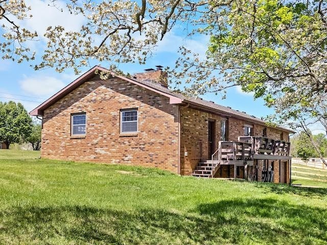 2355 Davidson Graveyard Rd, Clarksville, TN 37043 - back of house with brick siding, a wooden deck, a chimney, stairway, and a lawn