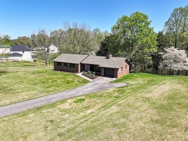2355 Davidson Graveyard Rd, Clarksville, TN 37043 - ranch-style home featuring a garage, asphalt driveway, a chimney, and a front lawn