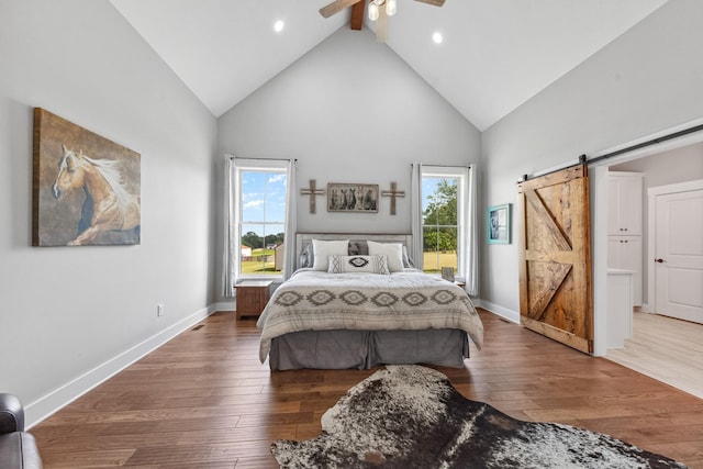 5247 Flat Creek Rd, Spring Hill, TN 37174 - bedroom featuring a barn door, high vaulted ceiling, wood finished floors, recessed lighting, and ceiling fan