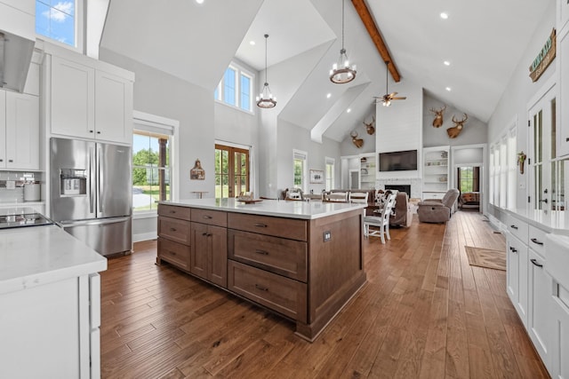 5247 Flat Creek Rd, Spring Hill, TN 37174 - kitchen with stainless steel fridge, high vaulted ceiling, white cabinetry, ceiling fan, and beam ceiling