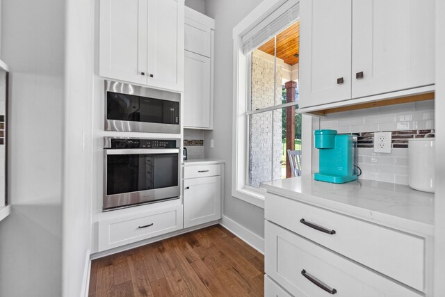 5247 Flat Creek Rd, Spring Hill, TN 37174 - kitchen featuring stainless steel appliances, tasteful backsplash, dark wood-style floors, white cabinets, and light stone countertops