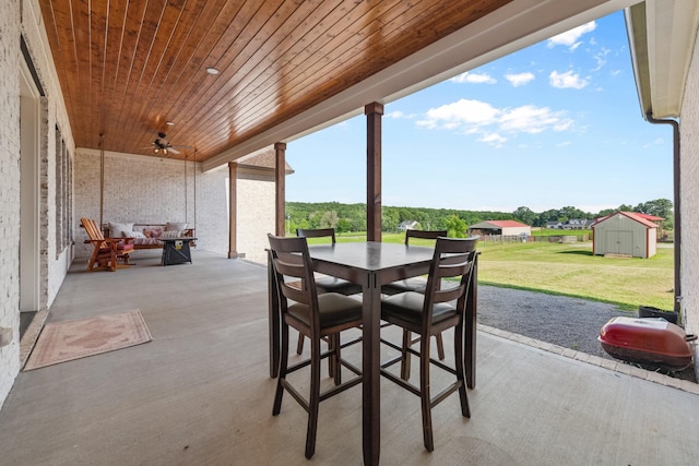 5247 Flat Creek Rd, Spring Hill, TN 37174 - view of patio featuring outdoor dining space, ceiling fan, and a shed