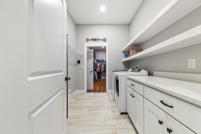 5247 Flat Creek Rd, Spring Hill, TN 37174 - washroom featuring washing machine and clothes dryer, cabinet space, and light marble finish floors