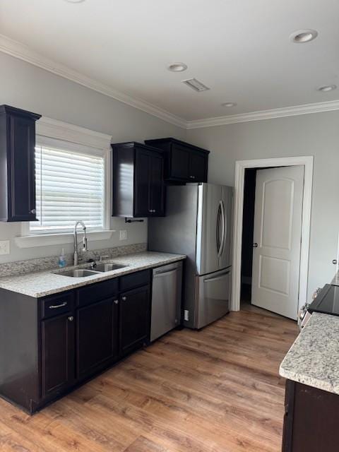 2747 Candlewick Ct, Murfreesboro, TN 37127 - kitchen featuring stainless steel appliances, ornamental molding, light wood-type flooring, light stone countertops, and recessed lighting