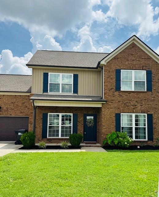 2747 Candlewick Ct, Murfreesboro, TN 37127 - view of front facade with a front yard, board and batten siding, brick siding, and a garage
