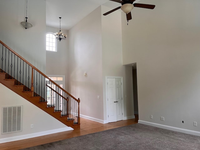 223 Sydney Dr, Goodlettsville, TN 37072 - unfurnished living room with a high ceiling, ceiling fan, a chandelier, stairway, and carpet floors