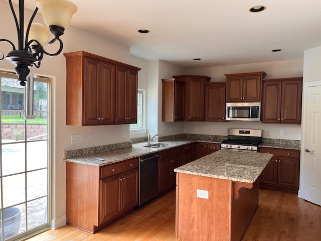 223 Sydney Dr, Goodlettsville, TN 37072 - kitchen with appliances with stainless steel finishes, light wood-type flooring, light stone countertops, a kitchen island, and recessed lighting