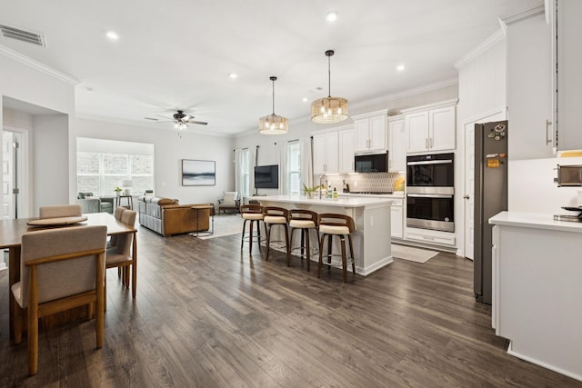 1434 Autumn Leaf Ln, Mount Juliet, TN 37122 - kitchen with stainless steel appliances, ornamental molding, recessed lighting, ceiling fan, and light countertops