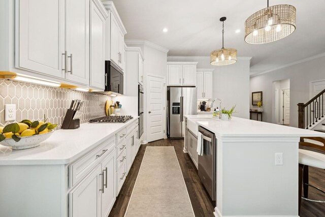 1434 Autumn Leaf Ln, Mount Juliet, TN 37122 - kitchen with appliances with stainless steel finishes, dark wood-style floors, crown molding, a kitchen island with sink, and backsplash
