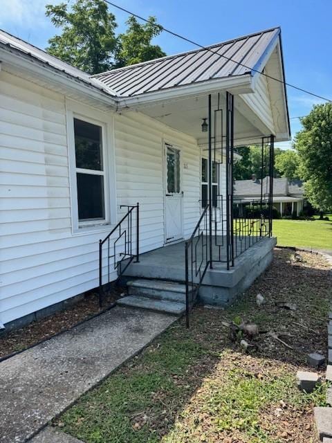 715 N High St N, Winchester, TN 37398 - view of exterior entry with a metal roof, a standing seam roof, and a porch
