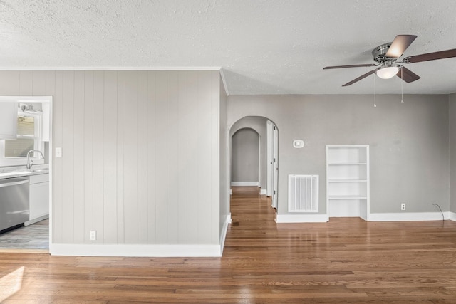 715 N High St N, Winchester, TN 37398 - unfurnished room with arched walkways, ceiling fan, wood finished floors, and a textured ceiling