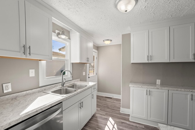 715 N High St N, Winchester, TN 37398 - kitchen featuring stainless steel dishwasher, light countertops, light wood-style flooring, a textured ceiling, and ornamental molding