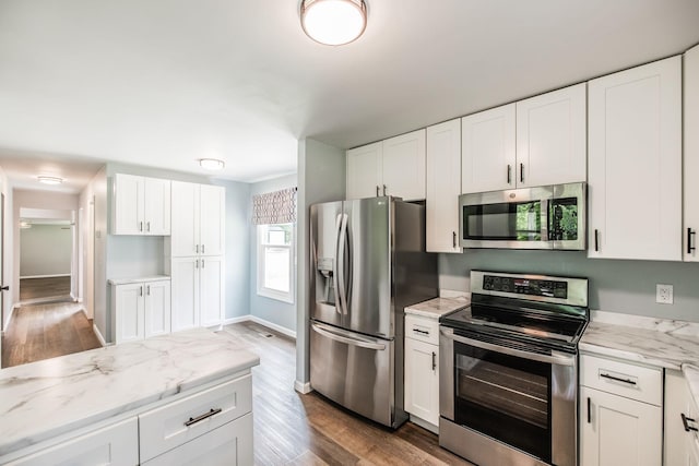 13989 Owens Chapel Rd, Springfield, TN 37172 - kitchen with stainless steel appliances, wood finished floors, white cabinets, and light stone counters