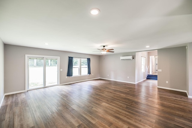 13989 Owens Chapel Rd, Springfield, TN 37172 - empty room featuring an AC wall unit, ceiling fan, dark wood finished floors, and recessed lighting