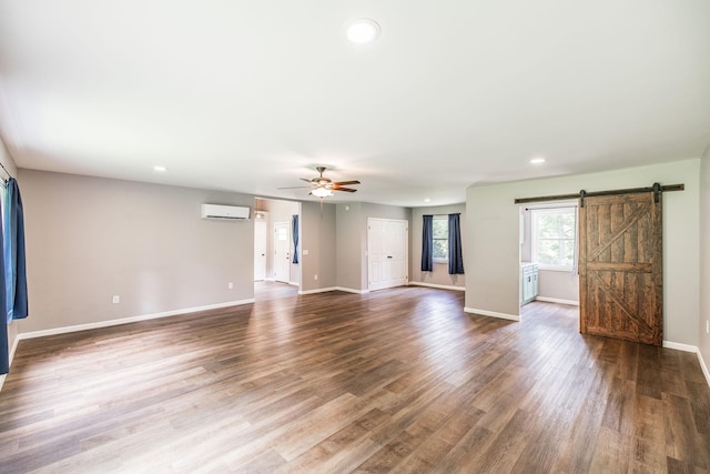 13989 Owens Chapel Rd, Springfield, TN 37172 - unfurnished living room with a barn door, a ceiling fan, recessed lighting, wood finished floors, and an AC wall unit