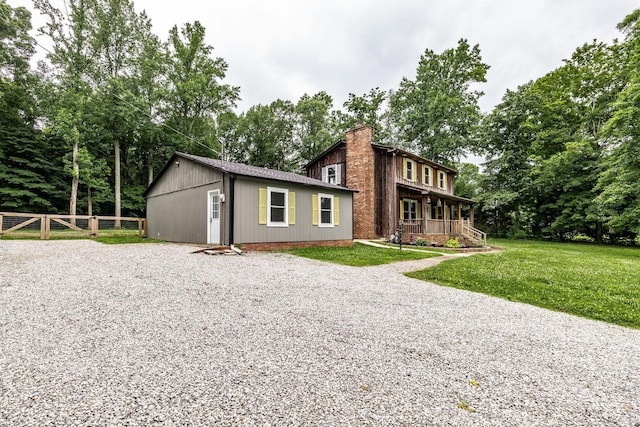 13989 Owens Chapel Rd, Springfield, TN 37172 - view of front of house with a chimney, a porch, driveway, and view of scattered trees