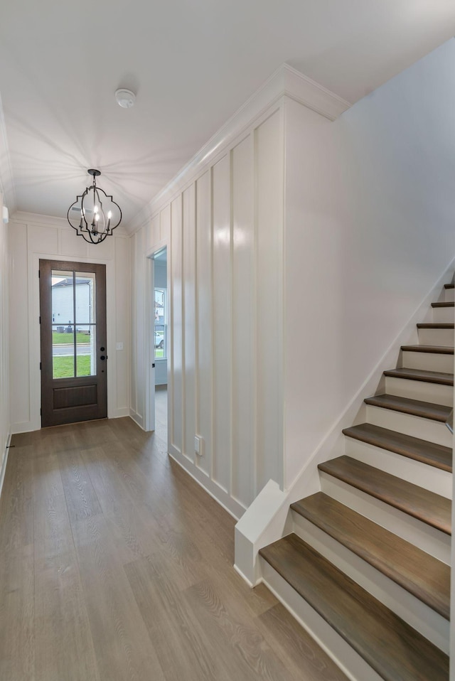 5743 Sagebrush Dr, Murfreesboro, TN 37129 - entrance foyer featuring wood finished floors, a chandelier, stairway, and ornamental molding