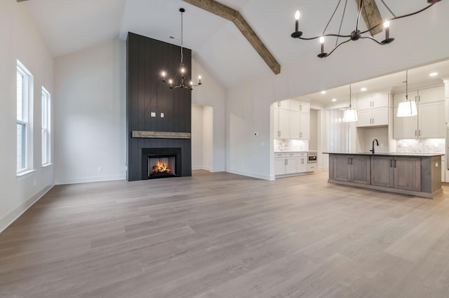 5743 Sagebrush Dr, Murfreesboro, TN 37129 - unfurnished living room featuring a chandelier, high vaulted ceiling, light wood-type flooring, and a fireplace