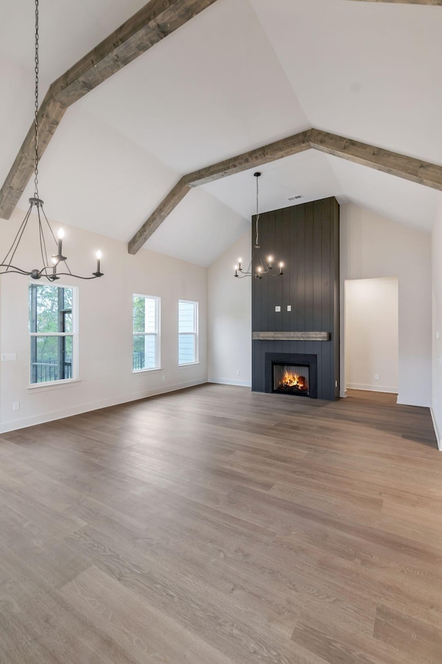 5743 Sagebrush Dr, Murfreesboro, TN 37129 - unfurnished living room with a chandelier, beam ceiling, wood finished floors, a large fireplace, and high vaulted ceiling
