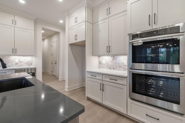 5743 Sagebrush Dr, Murfreesboro, TN 37129 - kitchen featuring double oven, light wood finished floors, tasteful backsplash, recessed lighting, and white cabinets