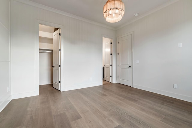 5743 Sagebrush Dr, Murfreesboro, TN 37129 - unfurnished bedroom with ornamental molding, a spacious closet, wood finished floors, a chandelier, and a closet