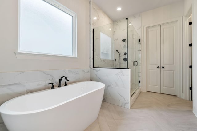 5743 Sagebrush Dr, Murfreesboro, TN 37129 - bathroom featuring a marble finish shower, a freestanding tub, and tile walls