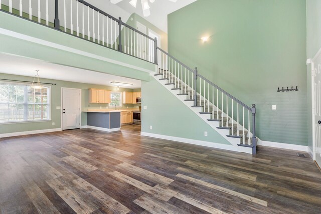 3406 Meadowhill Dr, Murfreesboro, TN 37130 - unfurnished living room with a towering ceiling, ceiling fan, dark wood-type flooring, and stairway