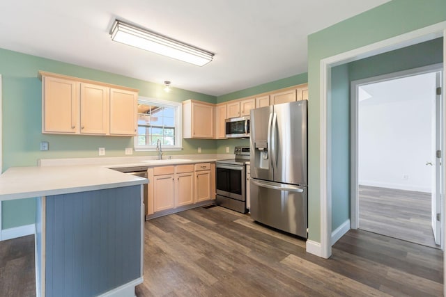 3406 Meadowhill Dr, Murfreesboro, TN 37130 - kitchen featuring appliances with stainless steel finishes, a peninsula, light brown cabinets, dark wood-style floors, and light countertops