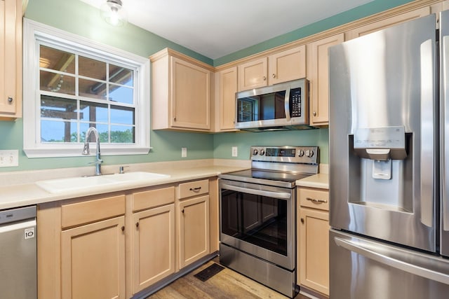 3406 Meadowhill Dr, Murfreesboro, TN 37130 - kitchen with appliances with stainless steel finishes, light brown cabinetry, light countertops, and wood finished floors