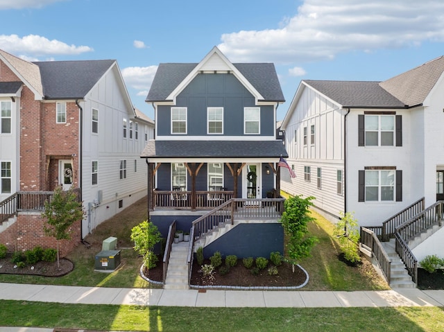 234 Sounder Cir, La Vergne, TN 37086 - view of front of house with stairway, a porch, board and batten siding, and roof with shingles