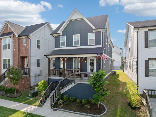 234 Sounder Cir, La Vergne, TN 37086 - view of front of home featuring a porch, a front lawn, board and batten siding, and stairway