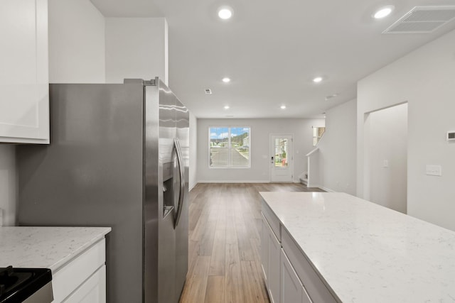 2509 Drumwright Way, Columbia, TN 38401 - kitchen featuring stainless steel fridge with ice dispenser, light wood-type flooring, open floor plan, light stone countertops, and recessed lighting