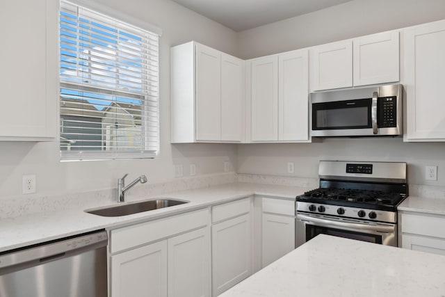 2509 Drumwright Way, Columbia, TN 38401 - kitchen featuring appliances with stainless steel finishes, white cabinetry, and light stone counters