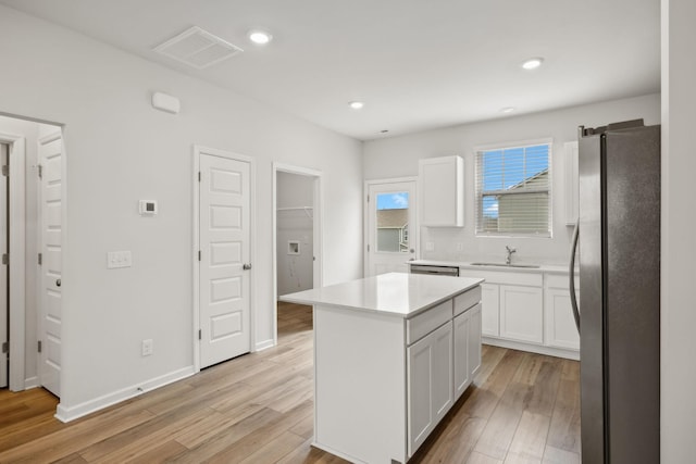 2509 Drumwright Way, Columbia, TN 38401 - kitchen with appliances with stainless steel finishes, white cabinets, light wood-style flooring, light countertops, and recessed lighting