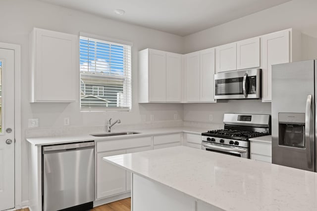 2509 Drumwright Way, Columbia, TN 38401 - kitchen featuring stainless steel appliances, white cabinetry, light stone counters, and light wood-style flooring