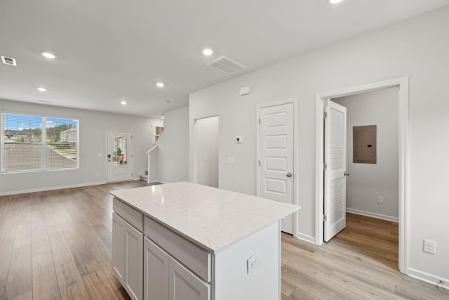 2509 Drumwright Way, Columbia, TN 38401 - kitchen with electric panel, a center island, open floor plan, light wood-style flooring, and recessed lighting