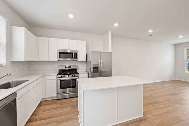 2509 Drumwright Way, Columbia, TN 38401 - kitchen with appliances with stainless steel finishes, a center island, recessed lighting, light wood-style floors, and white cabinetry
