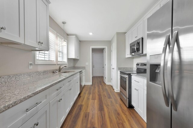 288 Springwater Dr, Summertown, TN 38483 - kitchen featuring appliances with stainless steel finishes, dark wood-style flooring, white cabinets, light stone counters, and recessed lighting
